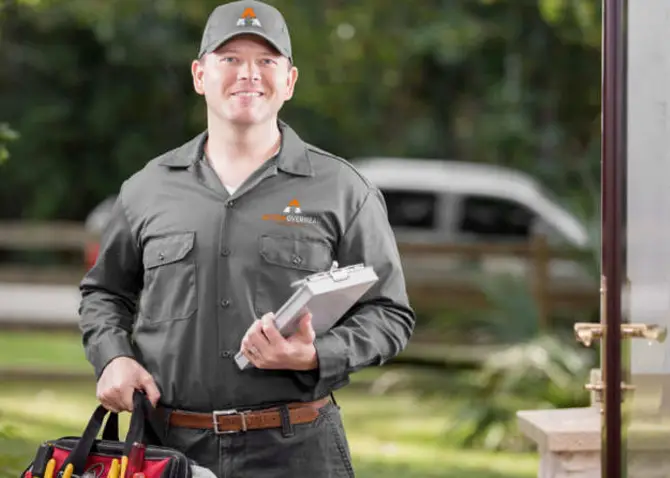Action Overhead skilled technician ready to repair a residential garage door