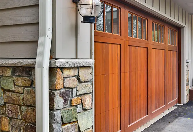 Custom wood garage door with windows, adding warmth and curb appeal to a modern residential home.