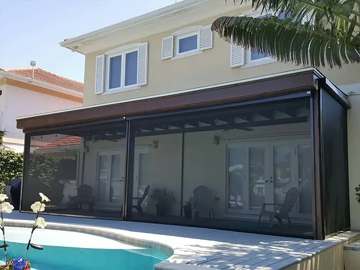 An image of a patio with roll up solar shades around it